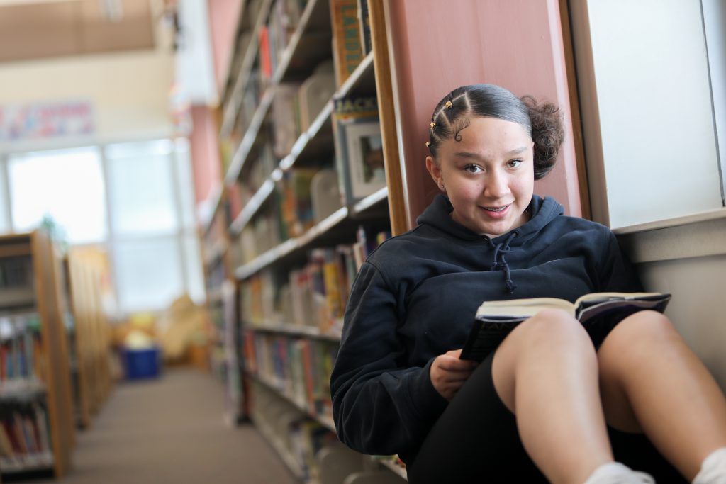 Student posing in the library